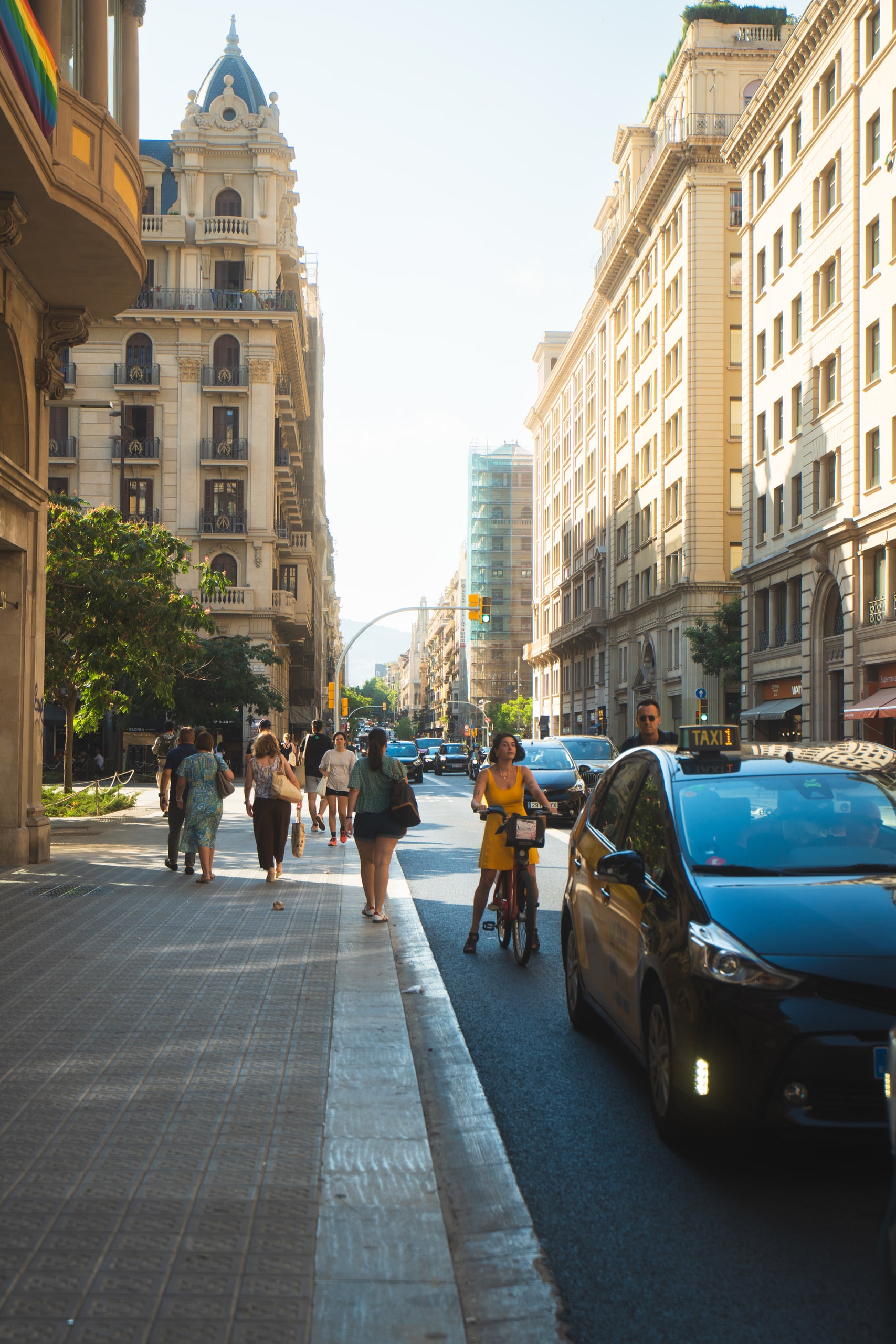 A wide city street lined with tall stone buildings