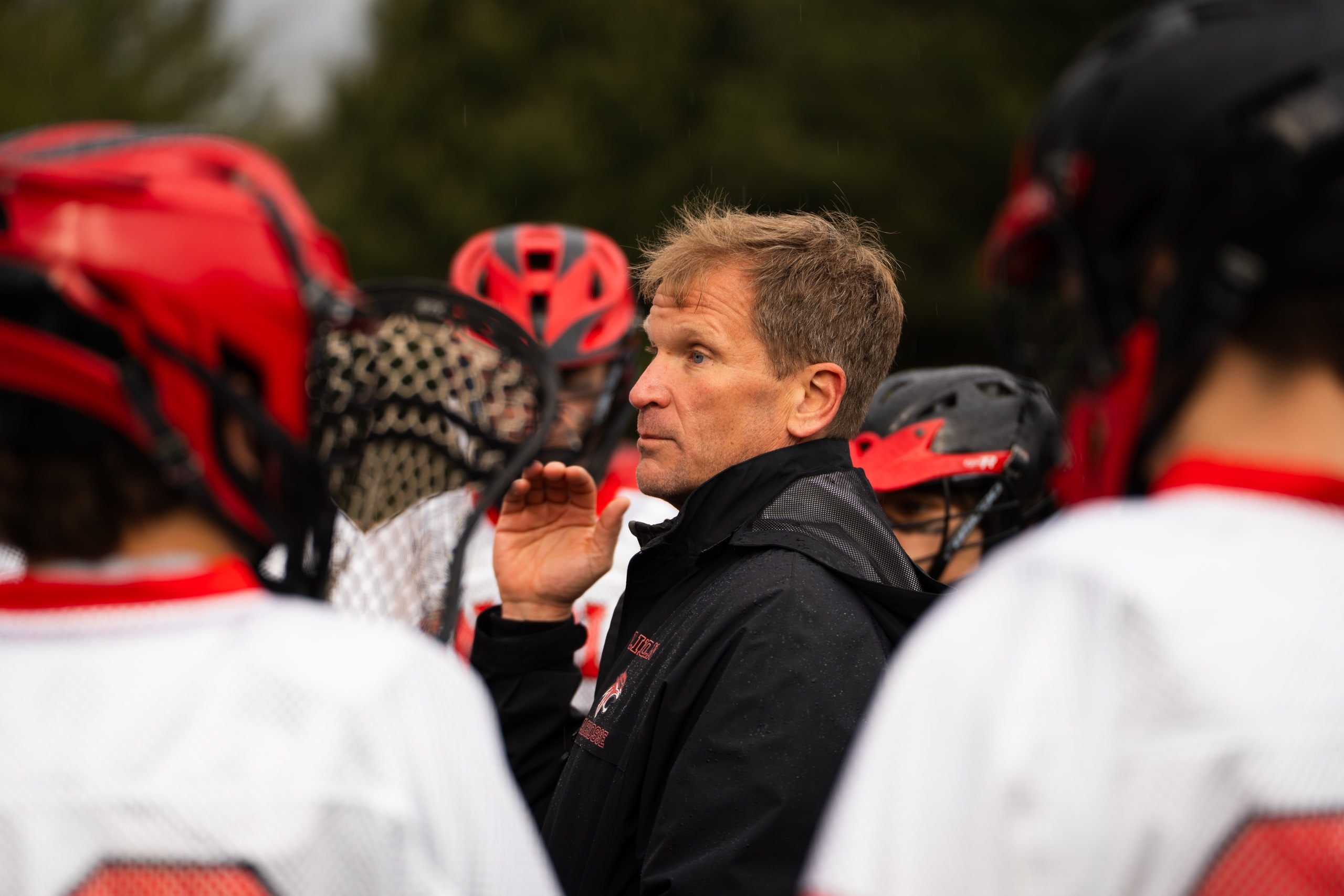 A coach talking to players gathered around him