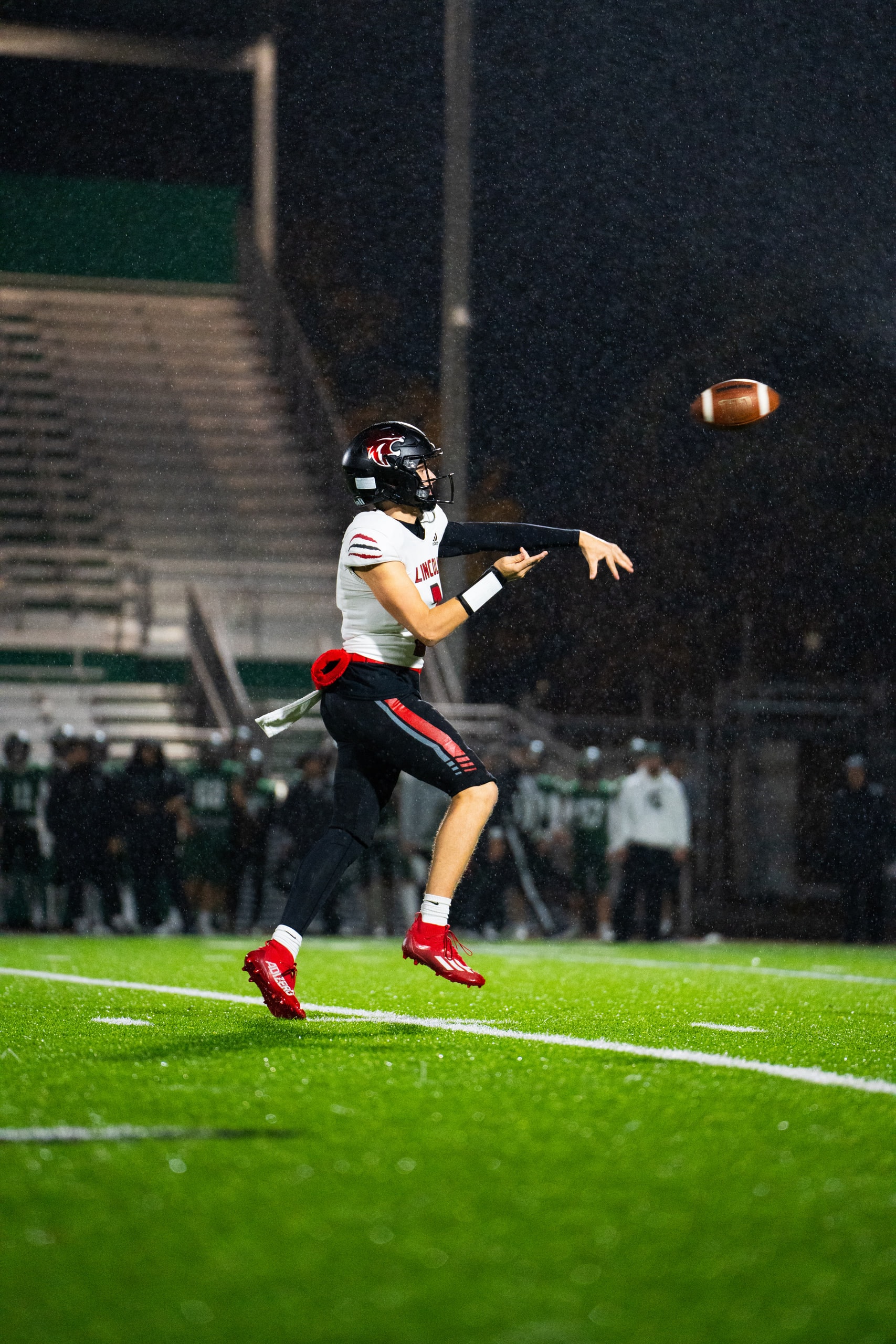 A quarterback releasing a pass downfield