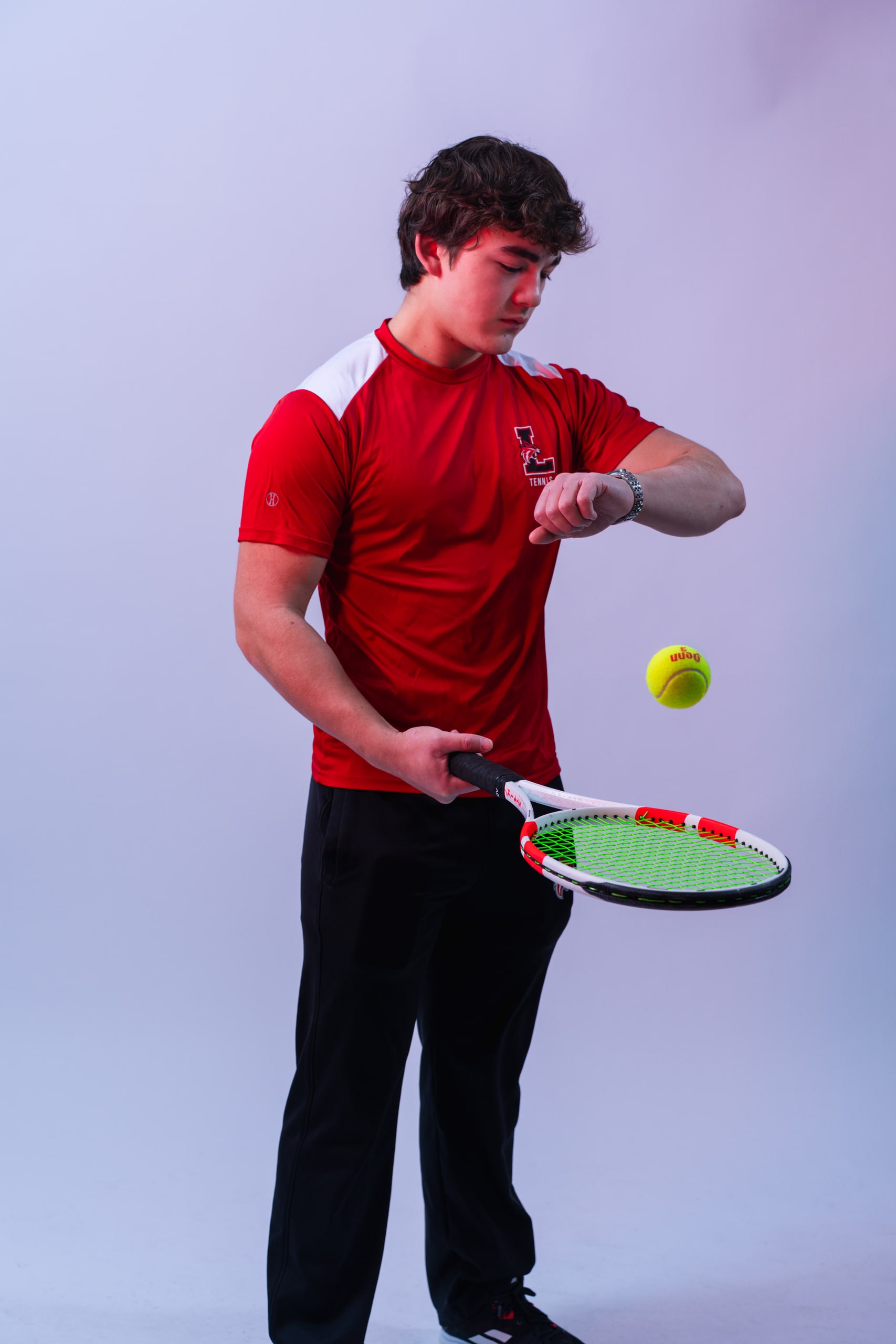 A player looking down at the ball on his strings